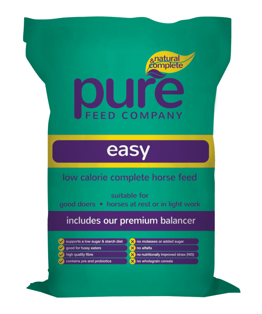 Bag of horse feed from Pure Feed Company. Feed is called Pure Easy because it is suitable for good doers, providing energy without the fizz. Bag is green with yellow and purple accents and some white text.