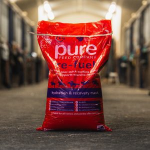 A 15kg bag of Pure ReFuel hydration and recovery mash from The Pure Feed Company placed inside a stable.